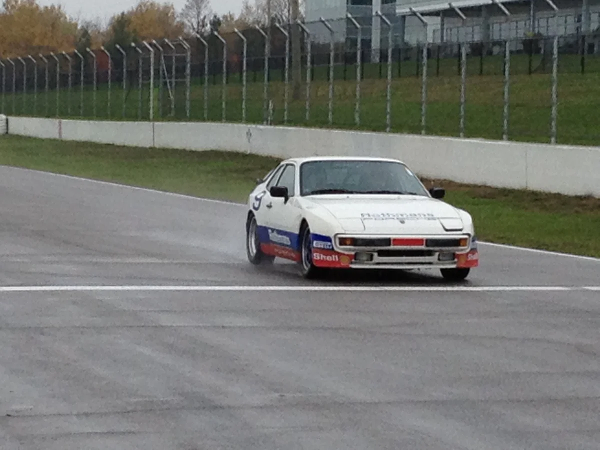 White number 9 Porsche on the race circuit